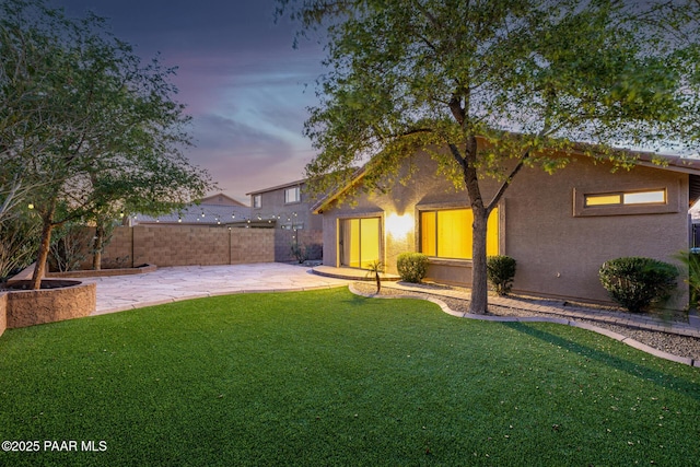 3713 W Nancy Ln, Phoenix, AZ 85041 - back of property at dusk with a patio area and stucco siding