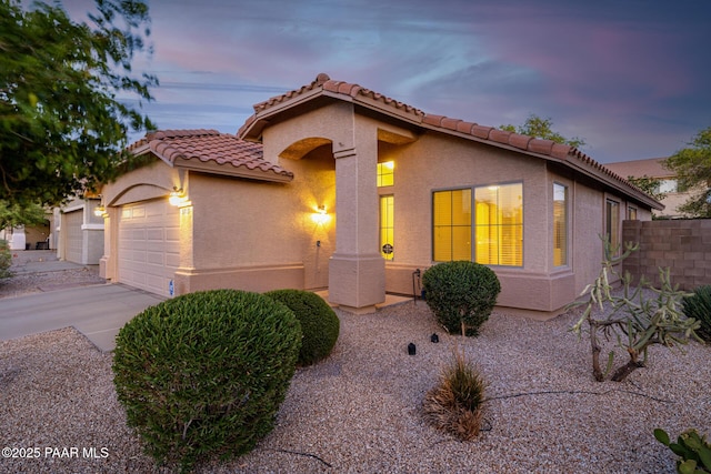 3713 W Nancy Ln, Phoenix, AZ 85041 - mediterranean / spanish home featuring an attached garage, stucco siding, concrete driveway, and a tile roof