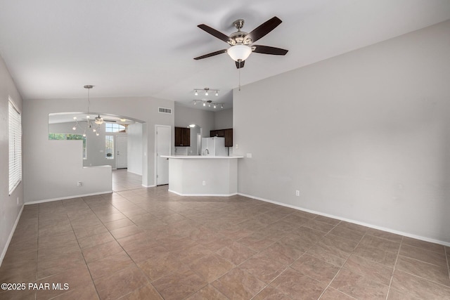 3713 W Nancy Ln, Phoenix, AZ 85041 - unfurnished living room with ceiling fan, vaulted ceiling, light tile patterned floors, arched walkways, and track lighting