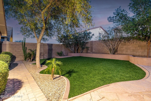 3713 W Nancy Ln, Phoenix, AZ 85041 - yard at dusk featuring a fenced backyard and a patio