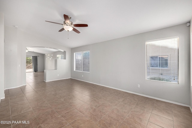 3713 W Nancy Ln, Phoenix, AZ 85041 - tiled spare room with a ceiling fan, arched walkways, and lofted ceiling