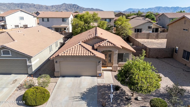 3713 W Nancy Ln, Phoenix, AZ 85041 - view of front of house featuring a residential view, an attached garage, a mountain view, and driveway