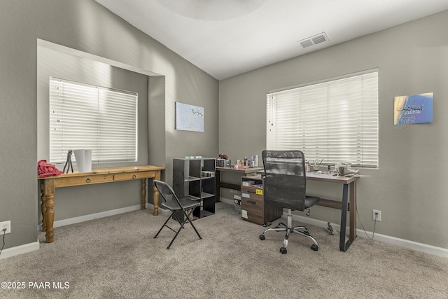 carpeted home office featuring visible vents, lofted ceiling, and baseboards