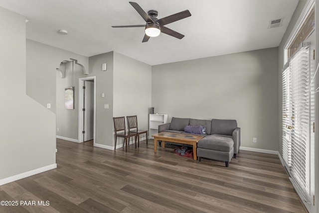 sitting room featuring dark wood finished floors, visible vents, a ceiling fan, and baseboards