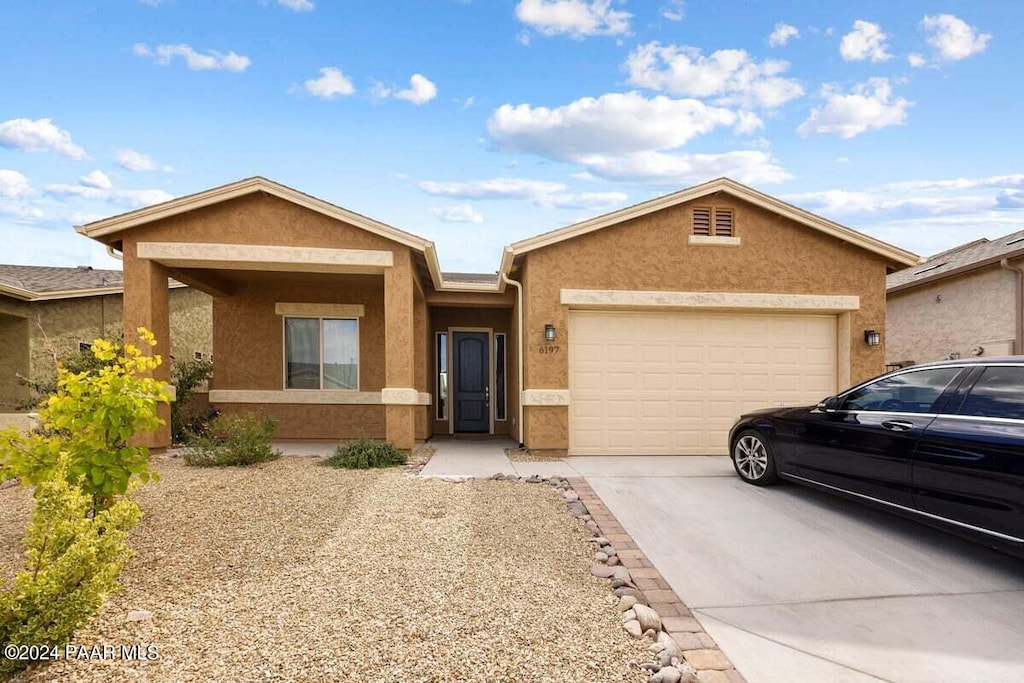 ranch-style home featuring a garage