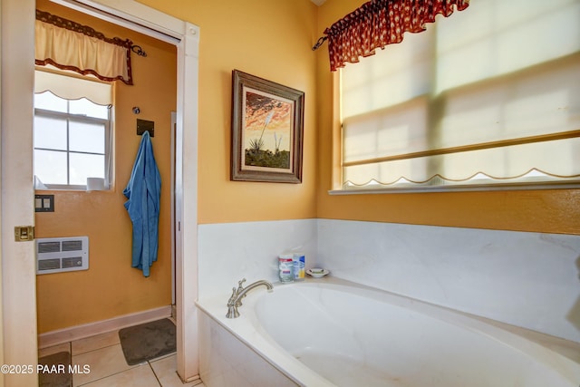 bathroom with baseboards, a wall mounted AC, a bath, and tile patterned floors