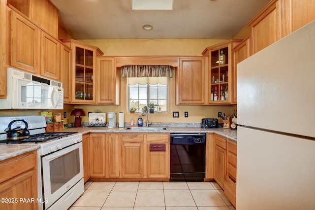 kitchen with light countertops, white appliances, light tile patterned flooring, and a sink