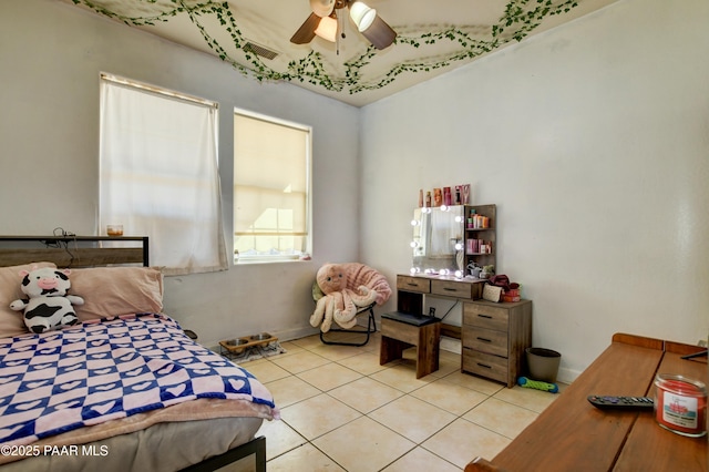 bedroom with baseboards, a ceiling fan, and light tile patterned flooring