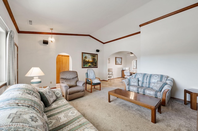 carpeted living room featuring crown molding, lofted ceiling, and ceiling fan