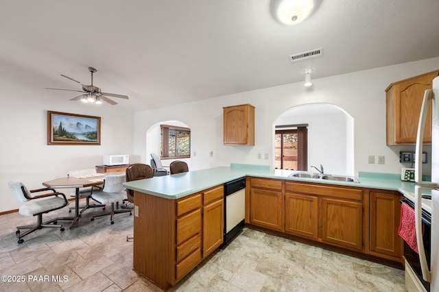 kitchen with ceiling fan, sink, white appliances, and kitchen peninsula