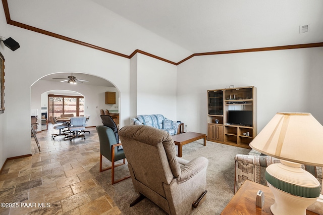 living room with crown molding, ceiling fan, and lofted ceiling