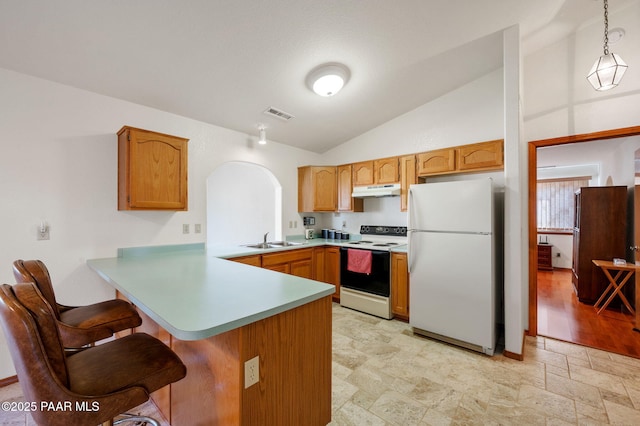 kitchen with sink, white appliances, hanging light fixtures, vaulted ceiling, and kitchen peninsula