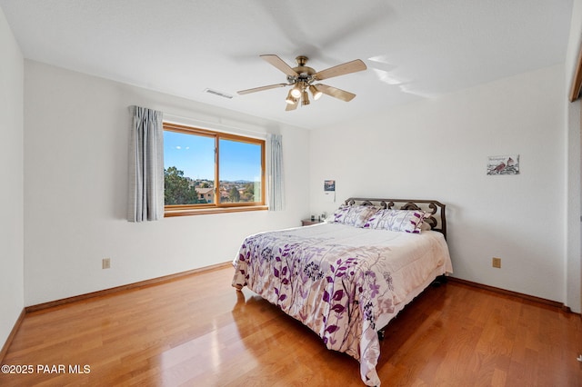 bedroom with hardwood / wood-style flooring and ceiling fan