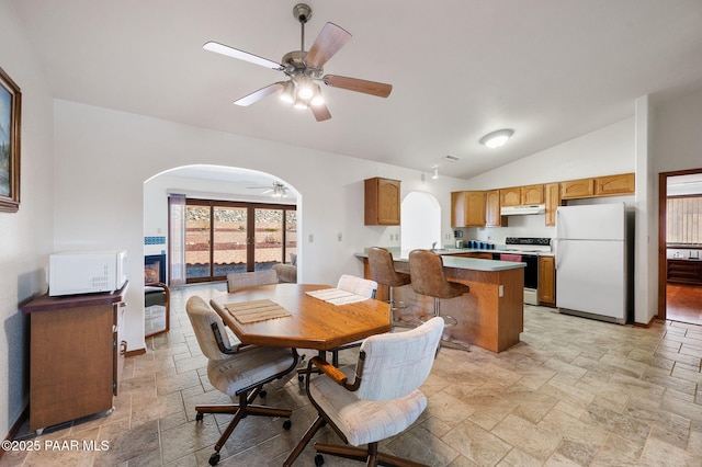 dining area with vaulted ceiling and ceiling fan