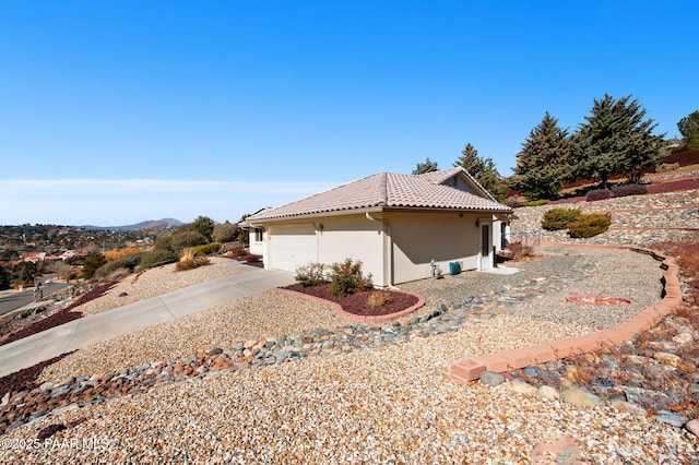 view of side of home featuring a garage