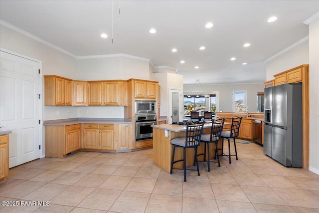 kitchen with a center island, stainless steel appliances, a kitchen breakfast bar, ornamental molding, and light tile patterned flooring