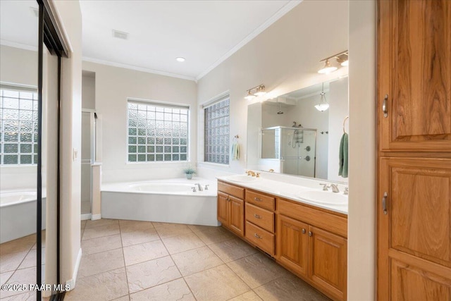 bathroom featuring tile patterned flooring, vanity, crown molding, and plus walk in shower