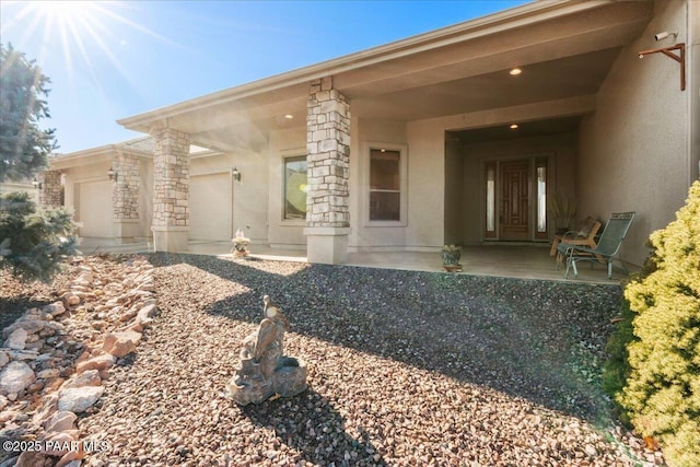 exterior space with a garage and a patio area