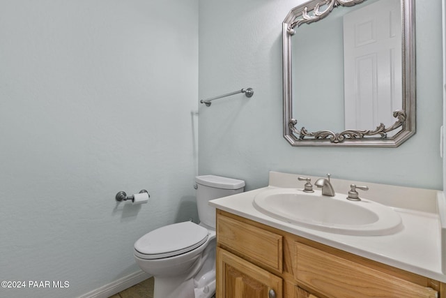 bathroom featuring toilet and vanity