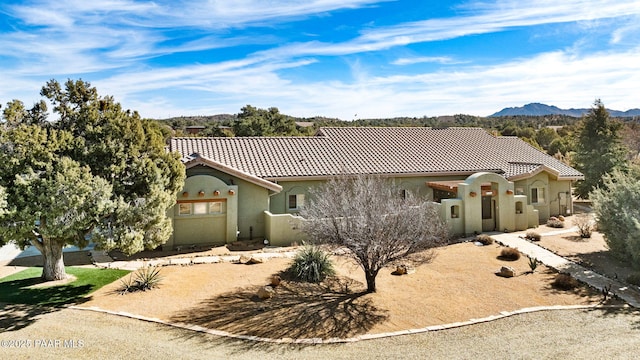 mediterranean / spanish-style home with a mountain view