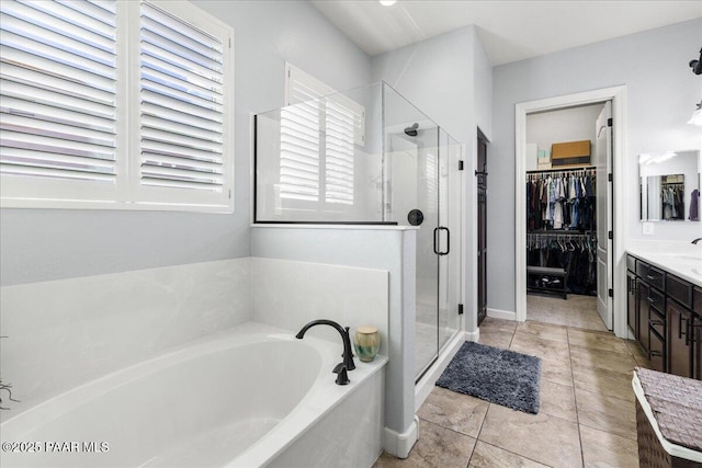 7123 E Roque Ln, Prescott Valley, AZ 86315 - bathroom with a bath, a shower stall, vanity, a spacious closet, and tile patterned flooring