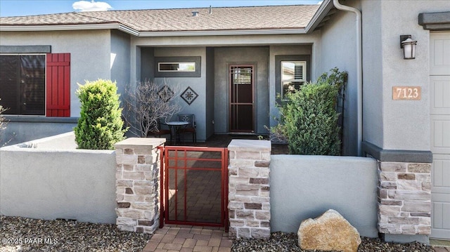 7123 E Roque Ln, Prescott Valley, AZ 86315 - entrance to property featuring stucco siding, a gate, fence, and a shingled roof