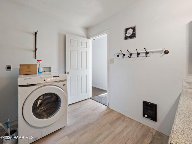 laundry area featuring washer / clothes dryer and light hardwood / wood-style flooring