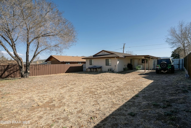 back of house featuring a fenced backyard