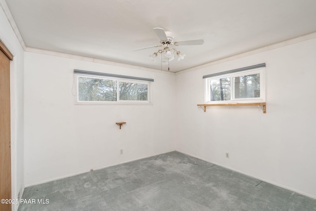 carpeted empty room featuring ornamental molding and ceiling fan