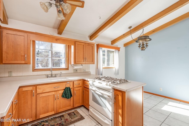 kitchen with sink, white gas stove, tasteful backsplash, light tile patterned floors, and kitchen peninsula