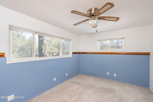 carpeted empty room featuring plenty of natural light and ceiling fan