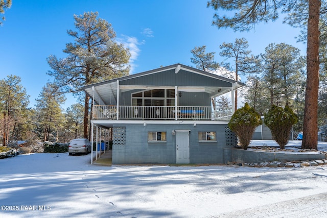 view of snow covered rear of property