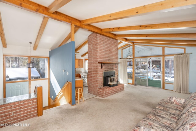 living room with lofted ceiling with beams, carpet, and a wood stove