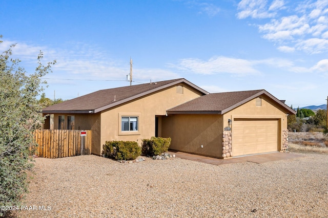 ranch-style home featuring a garage