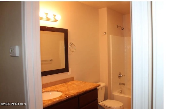 full bathroom with vanity,  shower combination, and toilet