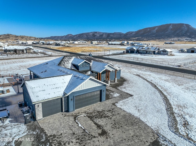 snowy aerial view with a mountain view