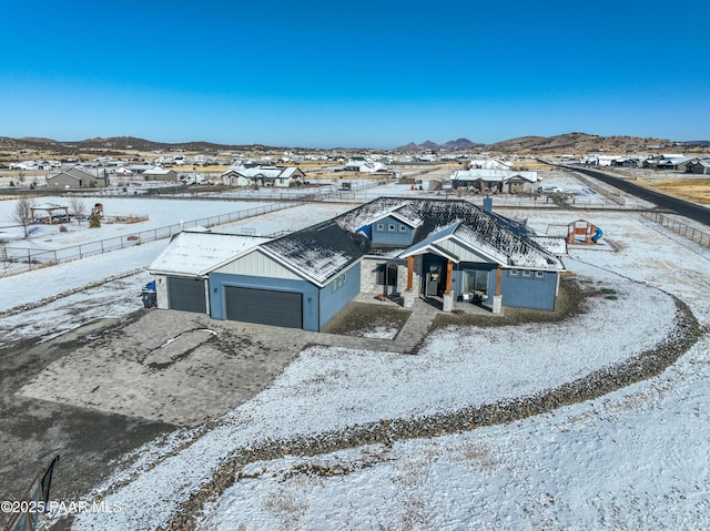 snowy aerial view with a mountain view