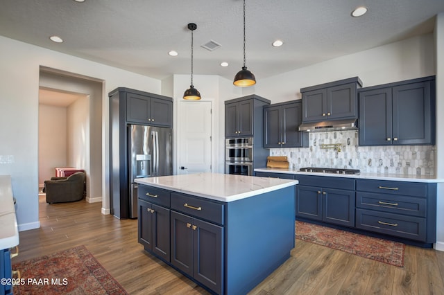 kitchen with a kitchen island, pendant lighting, tasteful backsplash, dark hardwood / wood-style flooring, and stainless steel appliances