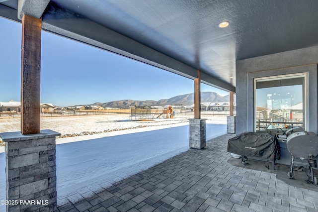 view of patio / terrace featuring a mountain view and a grill