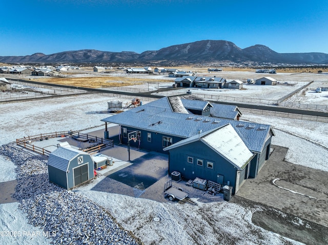 snowy aerial view featuring a mountain view