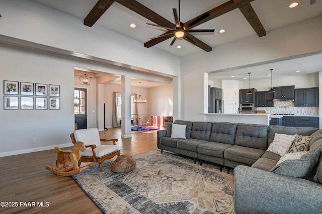 living room with beamed ceiling, a chandelier, and hardwood / wood-style floors