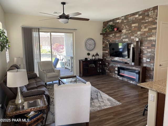 6175 Greer Ln, Prescott Valley, AZ 86314 - living room with a glass covered fireplace, ceiling fan, visible vents, and dark wood-type flooring