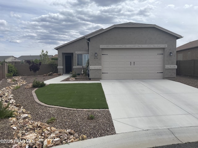 6175 Greer Ln, Prescott Valley, AZ 86314 - ranch-style home with fence, a front lawn, a garage, stucco siding, and driveway