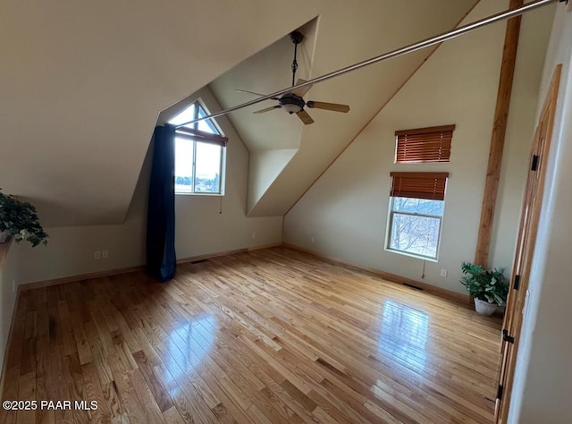 bonus room featuring ceiling fan, vaulted ceiling, baseboards, and wood finished floors