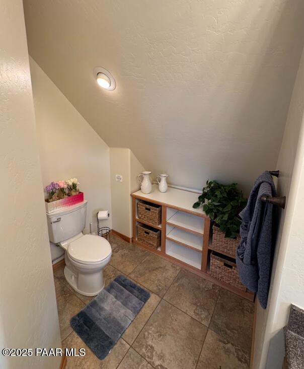 1740 W Bumblebee Rd, Chino Valley, AZ 86323 - bathroom featuring toilet, vaulted ceiling, and tile patterned flooring