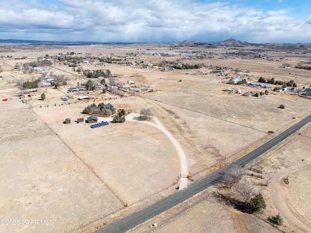 drone / aerial view featuring a rural view, a desert view, and a mountain view