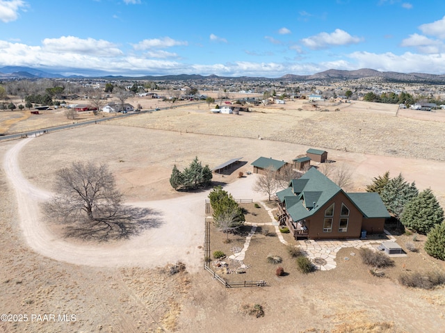 aerial view with a mountain view, a desert view, and a rural view