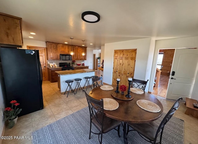 dining space featuring light tile patterned floors and recessed lighting