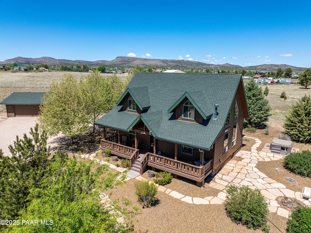 1740 W Bumblebee Rd, Chino Valley, AZ 86323 - view of front facade featuring a porch, a shingled roof, and a mountain view