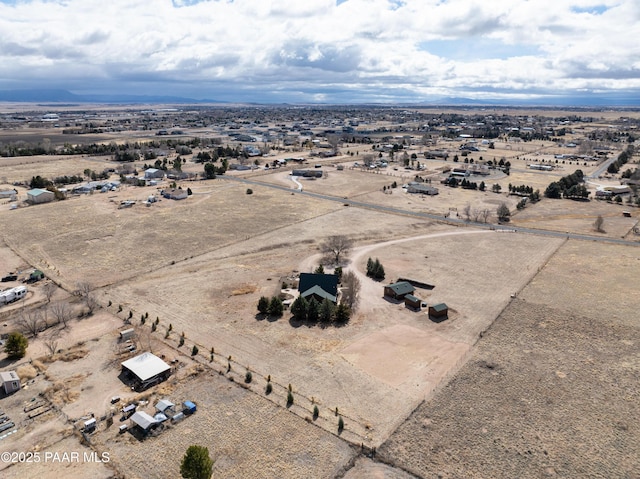 bird's eye view with view of desert and a rural view